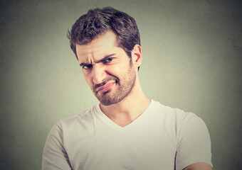 Portrait of a grumpy difficult man looking with disapproval and hatred 