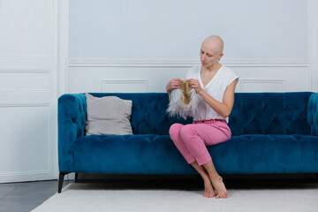 Bald woman in her forties struggle with treatment side effects