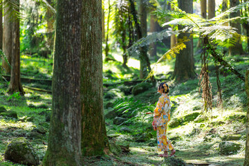 Asian woman try to wear Japanese kimono in the bamboo forest