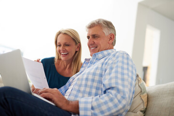 Couple, couch and document with laptop and laugh, finances or taxes for audit in living room....