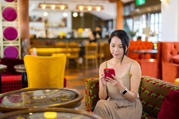 Woman use of mobile phone in coffee shop