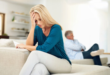 Woman, upset and mature couple on sofa for fight, disagreement or argument in living room,...