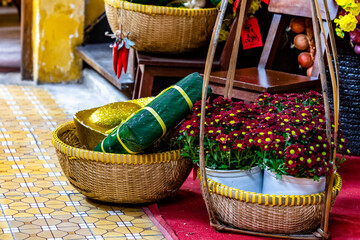 Sticky rice cake in lotus leaves, wooden forms and bowls for decor in Tet celebration