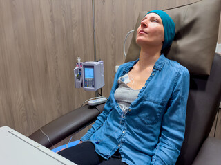 Woman in her forties with IV drip at cancer medical facility