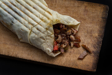 Doner Kebab Gyros Shawarma beef or chiken roll in pitta bread Wrap sandwich on wooden background