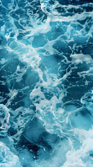 Pure blue turquoise water texture of the ocean sea with foam from and waves