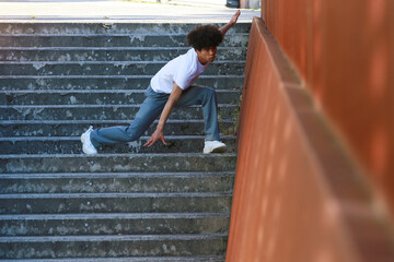 young urban african american man dancing in the street