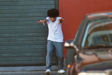 young urban african american man dancing in the street