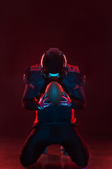 American football player banner on red neon background. Template for bookmaker ads with copy space....