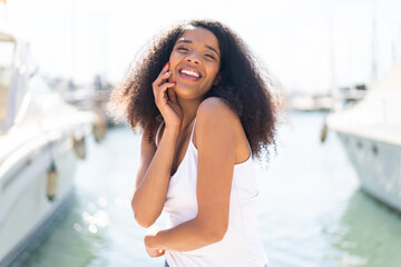 Young African American woman at outdoors With happy expression