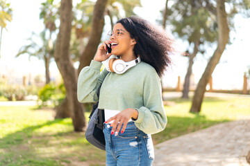 Young African American woman at outdoors using mobile phone