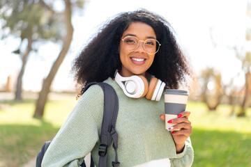 Young African American woman at outdoors holding a take away coffee