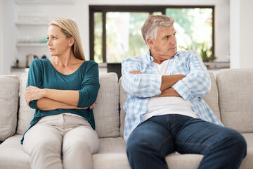 Mature, married and couple fight on sofa in home, people and domestic issue or ignore for...