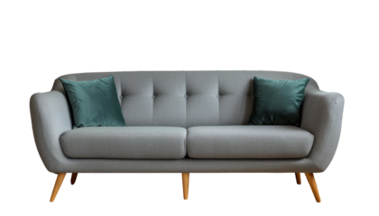 Contemporary grey fabric sofa with a sleek design and wooden legs, complemented by green velvet pillows. Ideal for modern living rooms seeking style and comfort, isolated on transparent background
