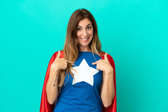 Super Hero caucasian woman isolated on blue background with surprise facial expression