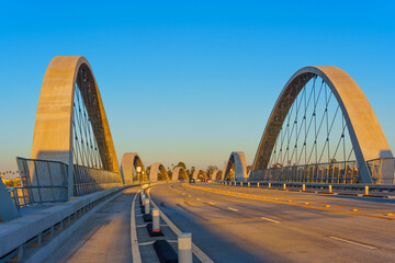 Modern Bridge with Distinctive Arches Against Clear Sky
