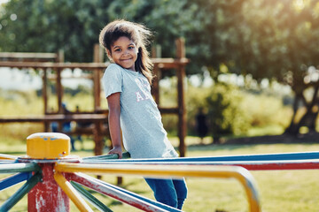 Portrait, child and carousel with playground, outside and love for summer break and play. Kid,...