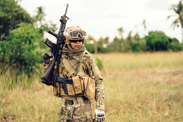 the battlefield's rugged terrain, soldiers stood ready, armed with M16 rifles, their protective helmets and night vision glasses providing them with a tactical advantage as they prepared to execute