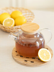 lemon tea in glass teapot isolated on white