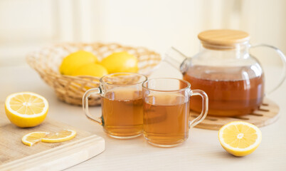 Fresh lemon and lemon tea in wooden dish