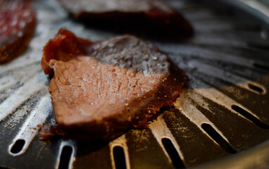 Beef steak on a barbecue grill, close up