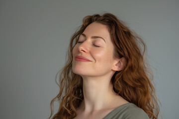 Fototapeta premium A close up of a woman's face with her eyes closed looking to a side