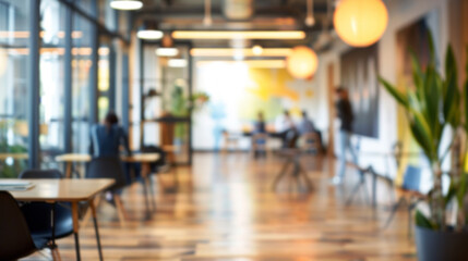 Blurred modern office background. Defocused image of a contemporary office space with natural light and people working in the background.