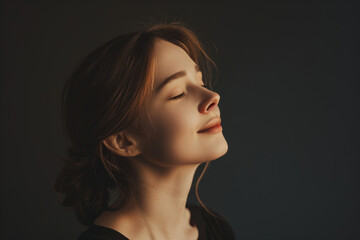 Fototapeta premium A close up of a woman's face with her eyes closed looking to a side