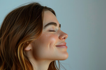 Fototapeta premium A close up of a woman's face with her eyes closed looking to a side