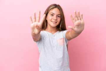 Little caucasian girl isolated on pink background counting nine with fingers