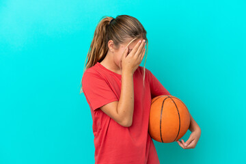 Little caucasian girl playing basketball isolated on blue background laughing