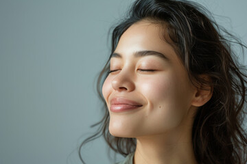 A close up of a woman's face with her eyes closed looking to a side