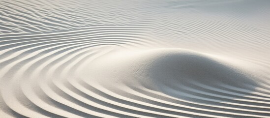 Fototapeta premium Top view of a tranquil white sand background with a soothing pattern for creating a Zen atmosphere conducive to meditation, with copy space image.