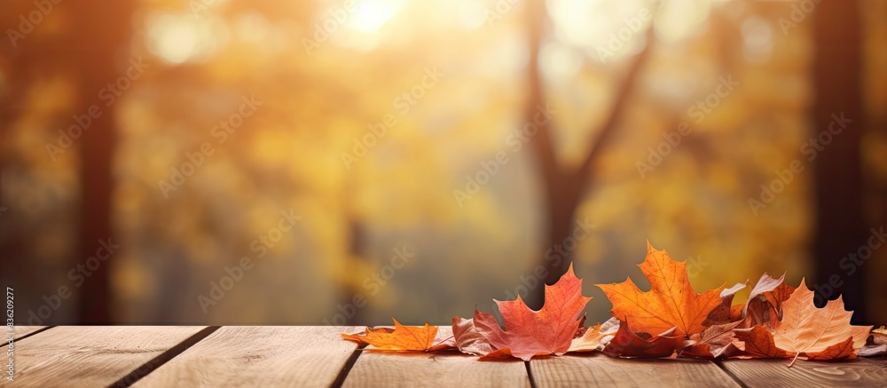 Poster autumn-themed background complements a wooden table with a clear surface for a vibrant copy space im