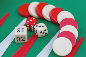 few dice rolling on green backgammon set, board games gambling addiction