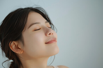 A close up of a woman's face with her eyes closed looking to a side