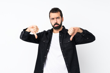 Young man with beard over isolated white background showing thumb down