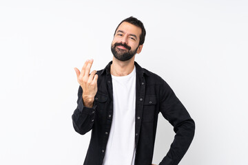 Young man with beard over isolated white background inviting to come with hand. Happy that you came