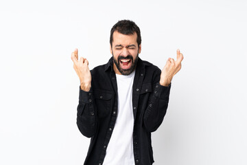 Young man with beard over isolated white background with fingers crossing