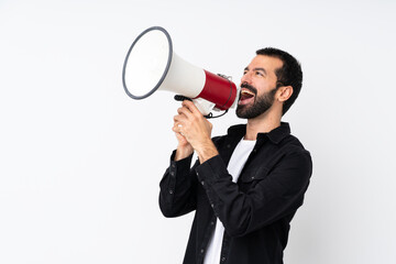 Young man with beard over isolated white background shouting through a megaphone