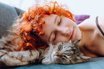 portrait red-haired teenage girl with gray fluffy cat
