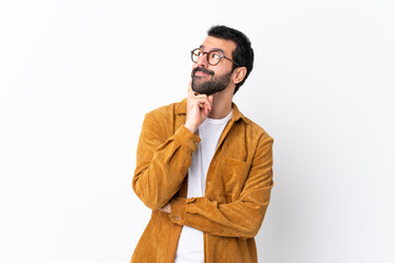 Caucasian handsome man with beard wearing a corduroy jacket over isolated white background thinking...