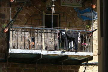 Washed laundry hangs on a rope outside the window.