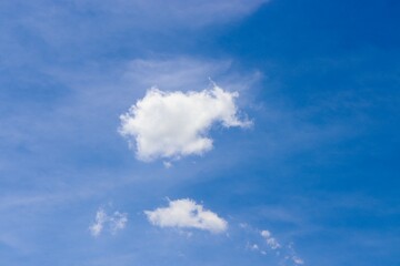 Some white clouds in the bright blue sky.