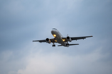 Airplane  registration flying on cloudy day, approaching landing in Tan Son Nhat Airport in Vietnam