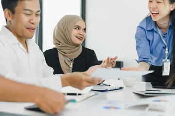 Diverse business professionals collaborating on project in modern office.