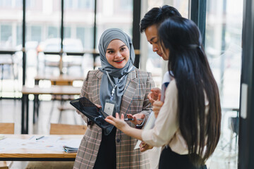 Three business professionals discussing charts in office.
