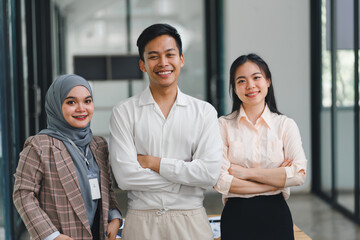 Diverse business team standing together in modern office.