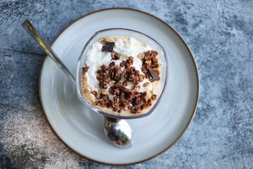 Iced caramel latte topped with whipped cream and caramel sauce, refreshing and sweet coffee drink