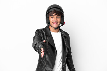 Young man with a motorcycle helmet isolated on white background shaking hands for closing a good...